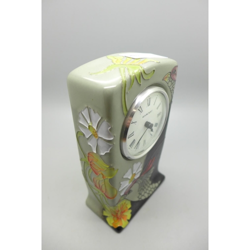 613 - A Moorcroft Courting Birds clock, 15cm