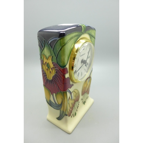 615 - A Moorcroft Anna Lily clock, 15cm