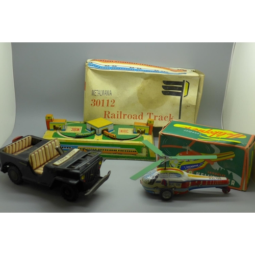 665A - A Japanese tin plate Jeep car, early 1960s, friction power, a Lendulet tin plate helicopter, made in... 