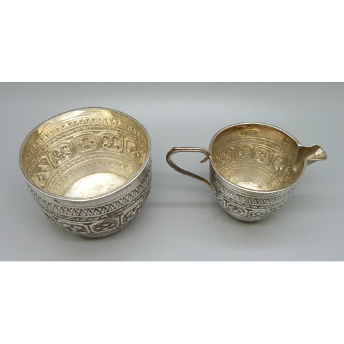 830 - A Victorian silver embossed cream jug and sugar bowl, Birmingham 1889/90, 124g