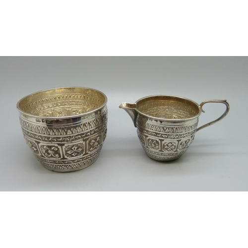 830 - A Victorian silver embossed cream jug and sugar bowl, Birmingham 1889/90, 124g