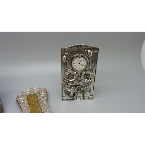 851 - A silver frame, Birmingham 1924, a plated clock, a smaller plated frame and a silver thermometer fra... 