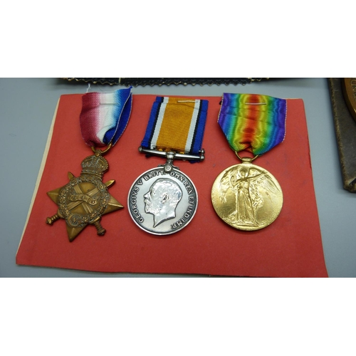 900 - A group of WWI medals including bronze death plaque and 'In loving memory' card and photo and histor... 