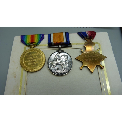 900 - A group of WWI medals including bronze death plaque and 'In loving memory' card and photo and histor... 