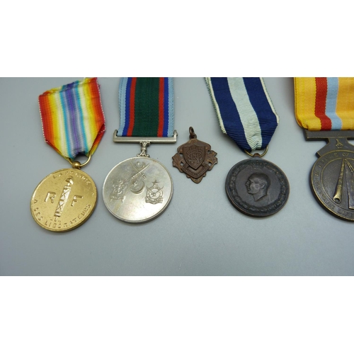 909 - Six assorted medals including Defence of Zimbabwe