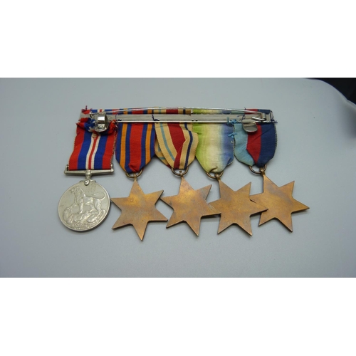 921 - An interesting Naval set of five WWII medals and modern miniatures along with complete service paper... 