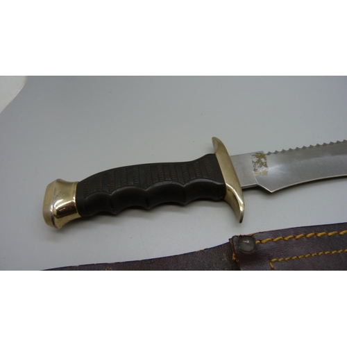 932 - A Muelay dagger with saw back, made in Spain, with leather scabbard