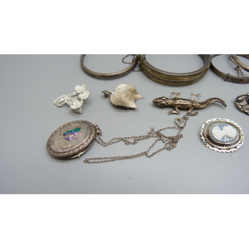 945 - Four silver lockets, six silver bangles, six brooches including silver