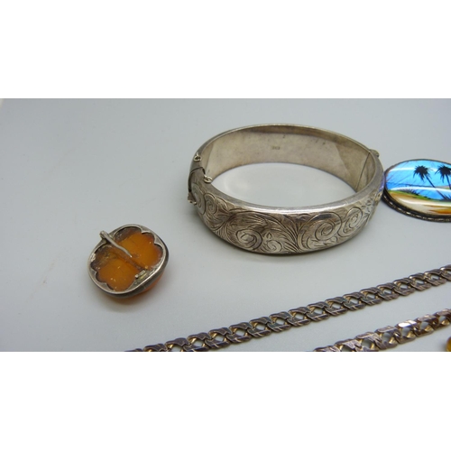 968 - A silver bangle, silver chain, butterfly wing brooch, etc.