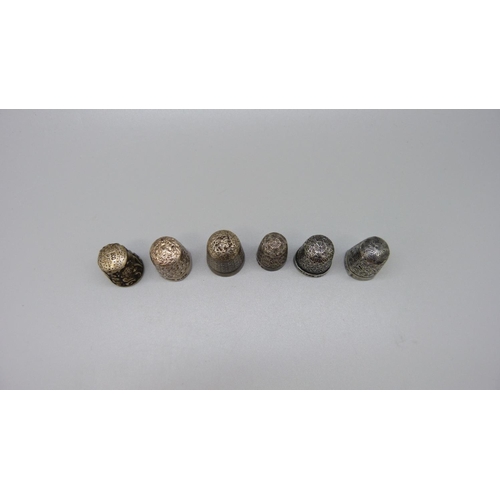 974 - Four silver thimbles and two others