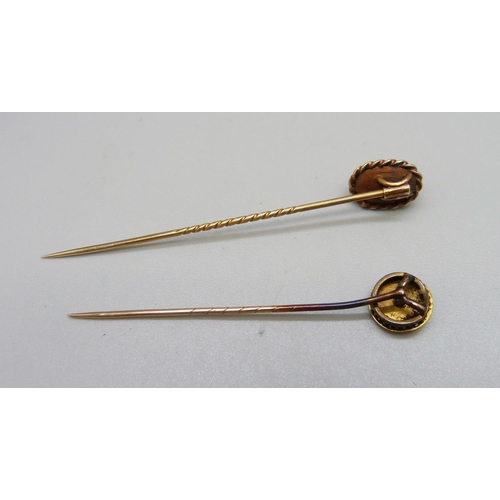 976 - Two yellow metal stick pins, one with cabachon stone, the other set with a diamond, 5.7g