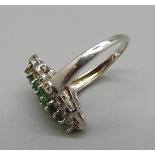 983 - A silver and emerald dress ring with diamond accents, O