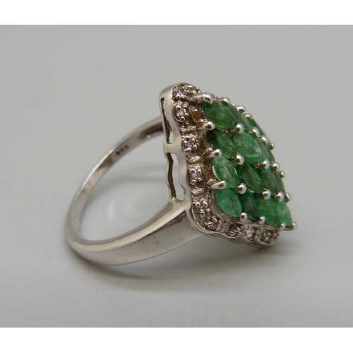 983 - A silver and emerald dress ring with diamond accents, O