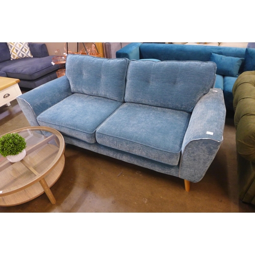 1525 - A teal velvet three seater sofa