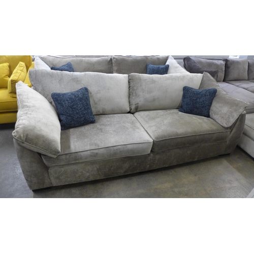 1524 - A mink upholstered four seater sofa with blue scatter cushions and black oak feet - £1799