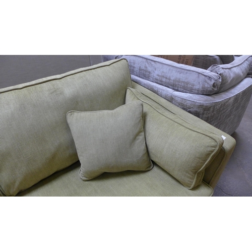 1545 - A lime green corduroy three seater sofa with black oak legs RRP £1439