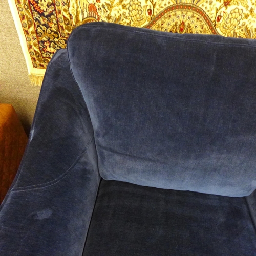 1558 - A deep ocean blue velvet oversized armchair with washed oak legs