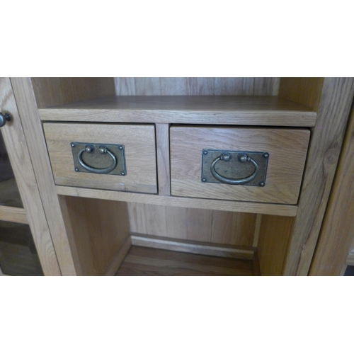 1570 - An oak three door, three drawer sideboard with dresser top