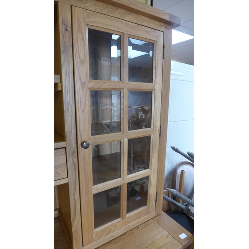 1570 - An oak three door, three drawer sideboard with dresser top