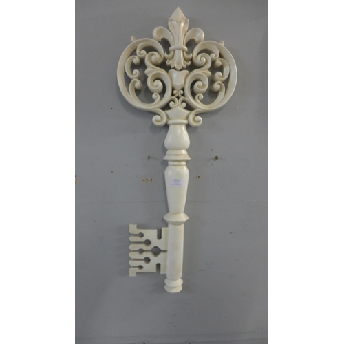 1313 - An antique white decorative key