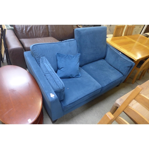 1702 - A midnight blue velvet two seater sofa (missing back cushion)