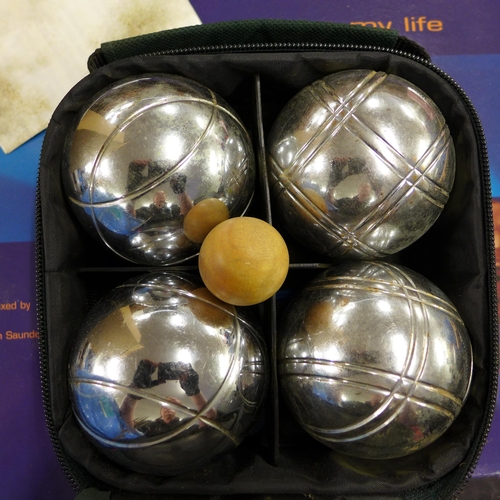 2054 - Bag containing a set of lawn bowls and a set of boule