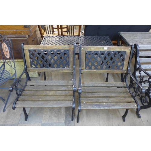 597 - A cast iron garden table and two chairs