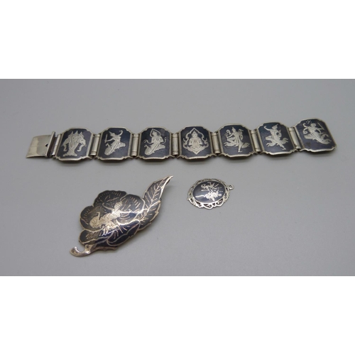 1054 - A Thai silver bracelet, brooch and pendant