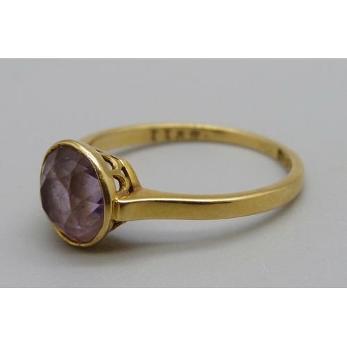 1121 - A yellow metal and amethyst ring, 2.2g, N, mark worn