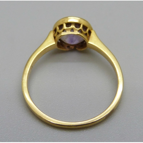 1121 - A yellow metal and amethyst ring, 2.2g, N, mark worn