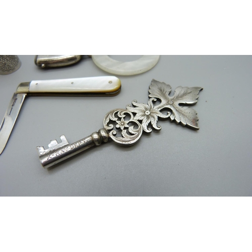 1128 - An 'X-Ray Department' white metal key, a Marcel Rochas French lipstick case, stamped inside, a silve... 