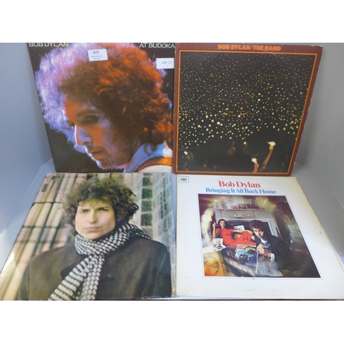 672 - A collection of eleven Bob Dylan LP records (three gatefold) and three Woody Guthrie LP records