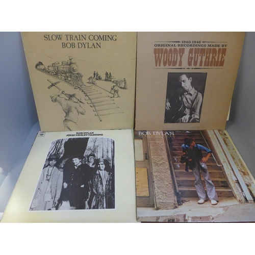 672 - A collection of eleven Bob Dylan LP records (three gatefold) and three Woody Guthrie LP records