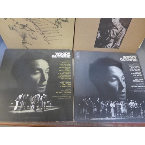 672 - A collection of eleven Bob Dylan LP records (three gatefold) and three Woody Guthrie LP records