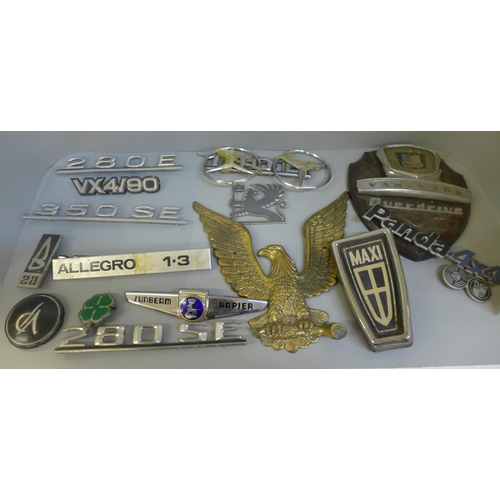 692 - A collection of assorted car badges and a plaque