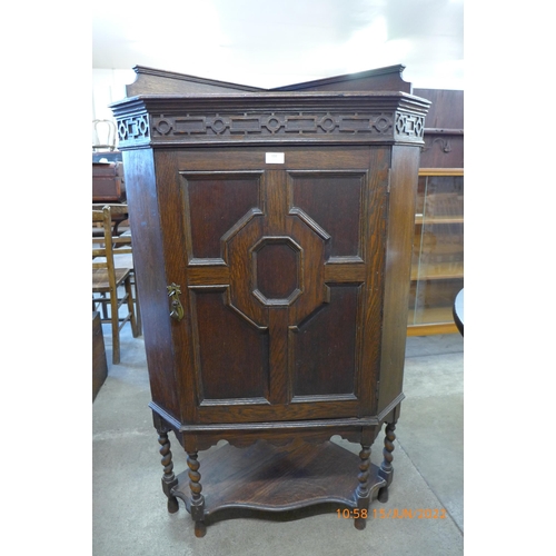 102 - An early 20th Century oak geometric moulded cover cupboard