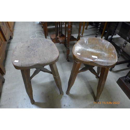 132 - A pair of elm and mahogany saddle seat kitchen stools