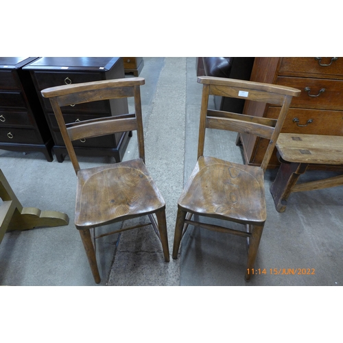 137 - A pair of Victorian elm and beech chapel chairs