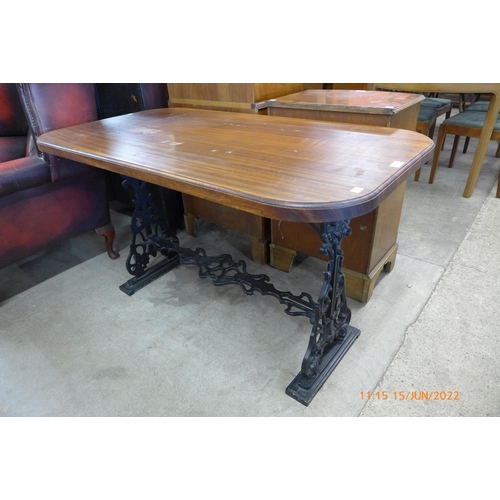 138 - A mahogany and cast iron based pub table