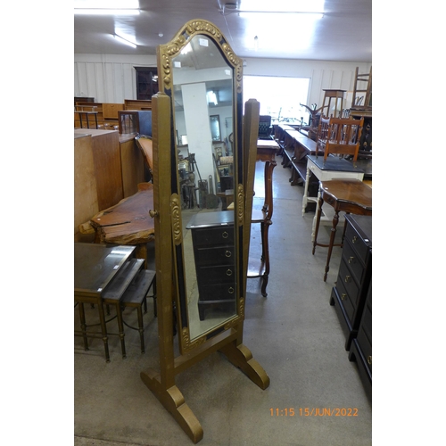 139 - An ebonised and gilt cheval mirror