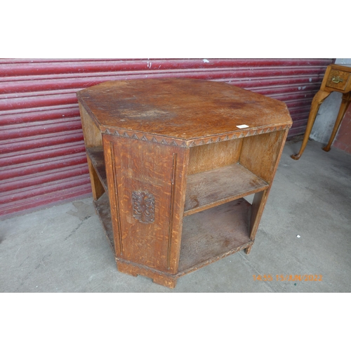 161b - An early 20th Century Heals style carved oak octagonal table/bookcase