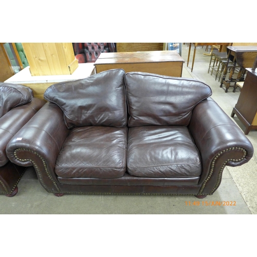 195 - A pair of brown leather settees