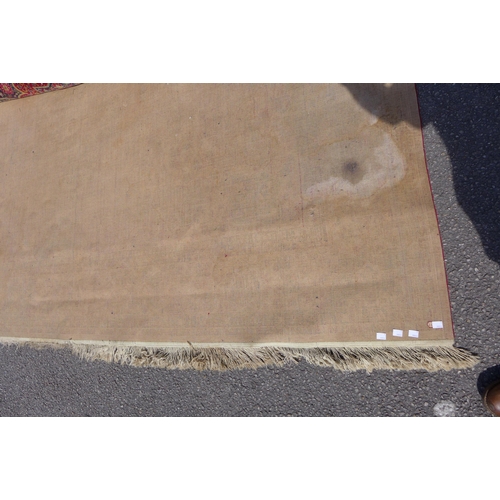 237 - A large red ground rug