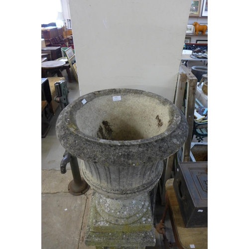 279 - A concrete campana shaped garden urn on pedestal