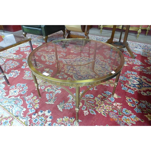 30 - An Italian brass and glass topped circular coffee table