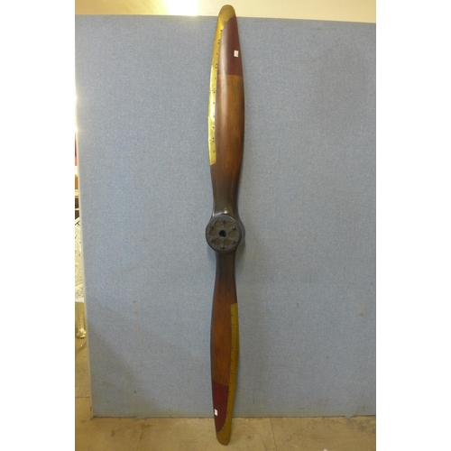 384 - A teak and brass mounted propeller