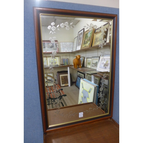 386 - An etched glass walnut framed mirror