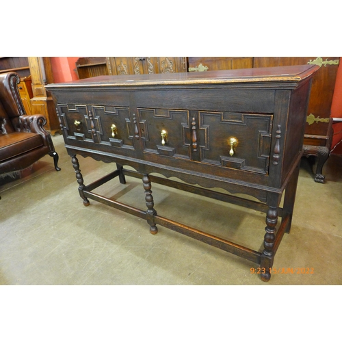 5 - An early 20th Century Jacobean Revival oak geometric moulded dresser