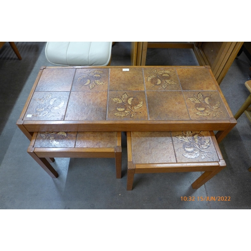 64 - A Danish teak and tiled top nest of tables