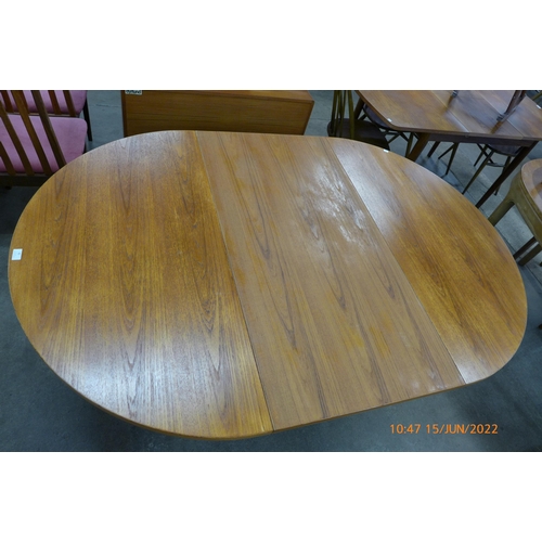 82 - A Danish teak extending dining table